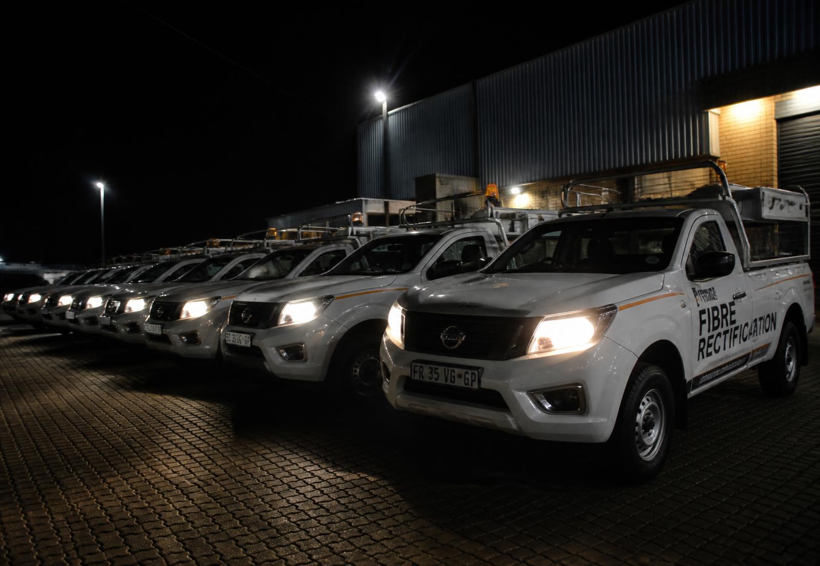 Fleet of fiber rectification vehicles at night